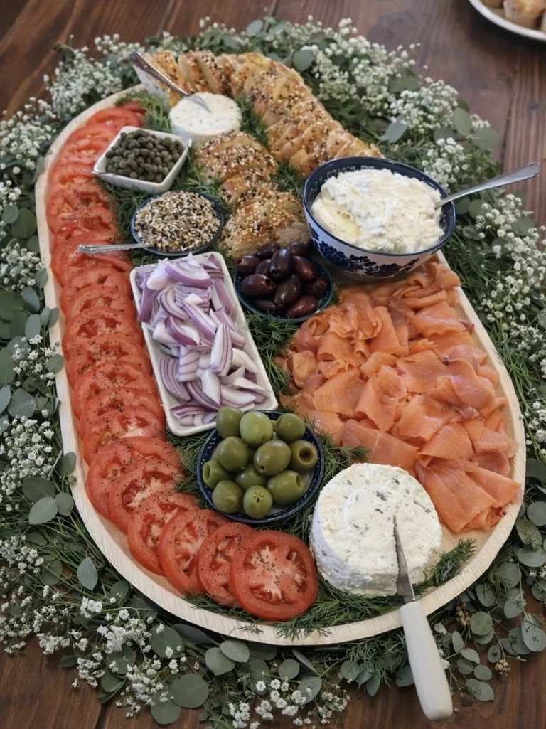 Brunch board with smoked salmon, herb goat cheese, capers, tomatoes and everything bagel baguette