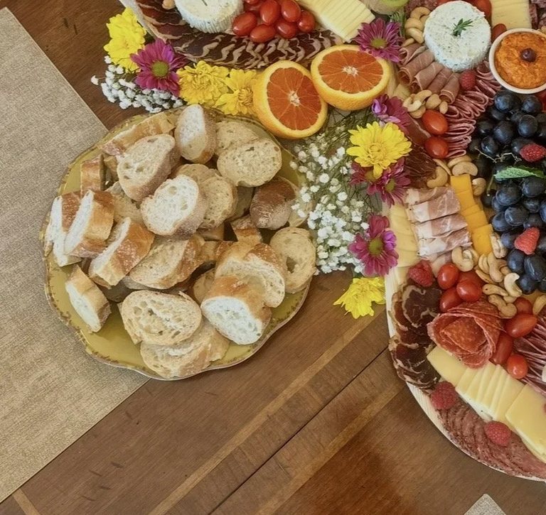Close detail of a platter of sliced baguette beside the grazing boards