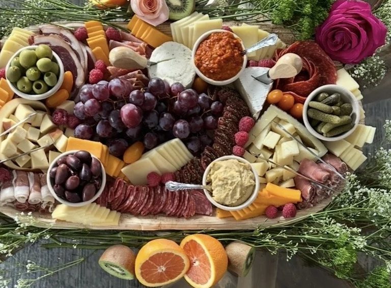 Close detail of red grapes at the centre of a MEZA grazing board