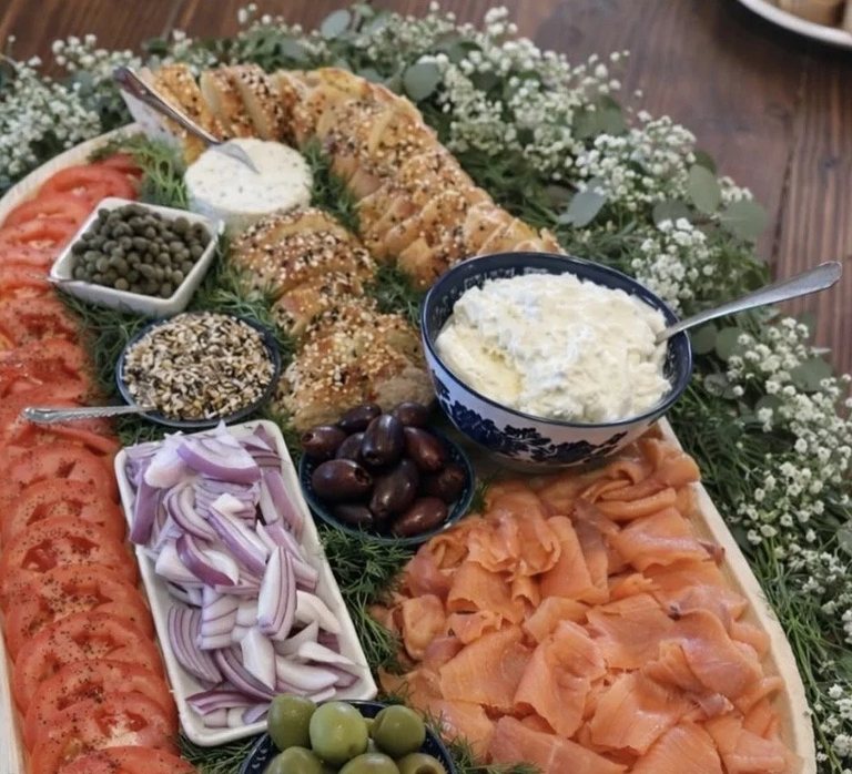 Close detail of smoked salmon, capers and whipped herb cheese on the brunch board