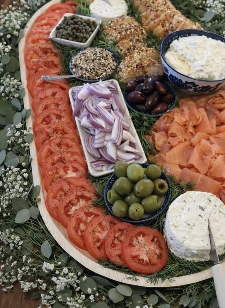 Close detail of sliced tomatoes, red onion and fresh dill on the brunch board